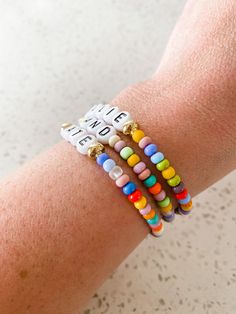 "Super FUN, multicolored bracelet! A very favorite of ours! -This is for one bracelet. -This bracelet is an assortment of the colors shown in the pictures with gold beads beside the name/word. If you don't want gold beads, please add that in the notes. -Choose whats letters/word(s) you would like in the 'add your personalization box'. -The bracelet is stretchy and goes on and off easily. -This bracelet comes in toddler, child, small adult, medium adult or large adult sizes. The medium adult size Multicolor Letter Beads Friendship Bracelets As Gift, Multicolor Beaded Name Bracelet For Gifts, Multicolor Beaded Name Bracelet As Gift, Everyday Multicolor Stretch Bracelet With Spacer Beads, Colorful Bracelets With Spacer Beads For Gifts, Colorful Bracelets With Spacer Beads As Gift, Personalized Multicolor Round Bead Friendship Bracelets, Multicolor Name Bracelet With 8mm Beads For Gift, Multicolor Round Beads Name Bracelet As Gift