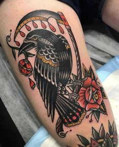 a black bird sitting on top of a person's leg with flowers around it