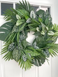 a green wreath hanging on the front door