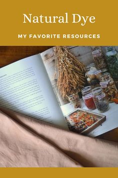 an open book sitting on top of a bed next to a pile of books with the title natural dye my favorite resources