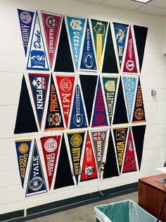 a wall with many pennants hanging on it