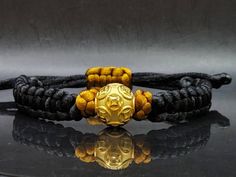 Gift yourself or your love once this Unisex Money Ball Bracelet. Crafted with 24 Karat Gold amd Mandala String. *Karat: Au999 Pure Gold *Gold Color: Yellow *Gold Weight; 1.63grams *LENGTH: Adjustable *Band Width: 10.4mm *Money Ball Size: 14.1mm *Real 24K Gold. NOT gold filled. NOT gold Plated. Pls message us if you want to customize your bracelet a certain way and we'll be happy to help you 💥PLS FOLLOW US AND CHECK OUR OTHER LISTINGS. WE HAVE NEW STOCKS LISTED DAILY/WEEKLY. 📬S H I P P I N G WE Adjustable Gold Wristband With Round Beads, Adjustable Gold Bracelet Wristband, Adjustable Gold Wristband Bracelet, Spiritual Gold Braided Bracelets With Round Beads, Gold Spiritual Wristband With Round Beads, Adjustable Gold Wristband For Gift, Adjustable Gold Wristband As Gift, Spiritual Gold Braided Round Bracelets, Gold Spiritual Braided Bracelets