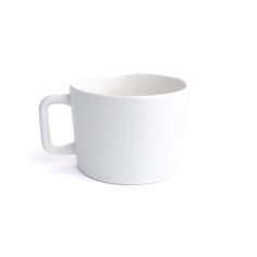 a white coffee cup sitting on top of a table