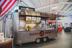 a silver food truck parked inside of a building