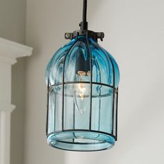 a blue glass light fixture hanging from a ceiling