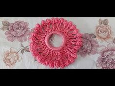 two pink scrunffles sitting on top of a table cloth covered in flowers