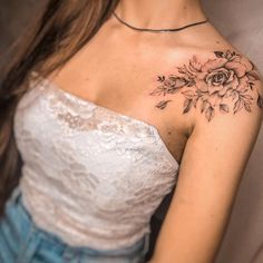 a woman with a flower tattoo on her shoulder