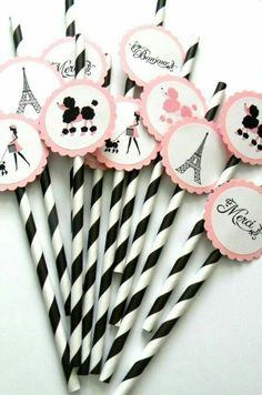 some black and white striped straws with pink designs on them are sitting next to each other