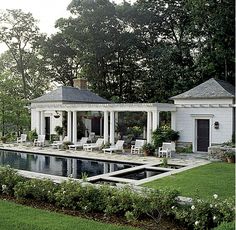 a house with a pool in front of it and some chairs around the pool area