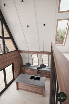 an aerial view of a kitchen and living room in a house with high vaulted ceilings