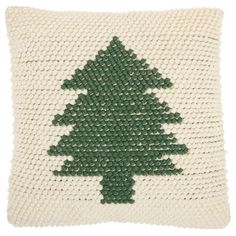 a knitted pillow with a green christmas tree on it