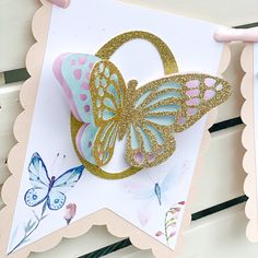 a card with a butterfly on it and some butterflies hanging from the back of it