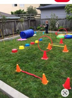 children playing in the yard with plastic cones and obstacles