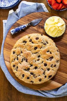 a chocolate chip cookie on a wooden cutting board