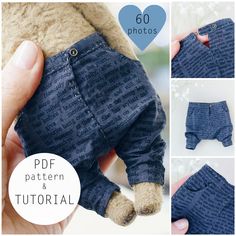 a hand holding a small stuffed animal in blue pants with buttons on the front and bottom