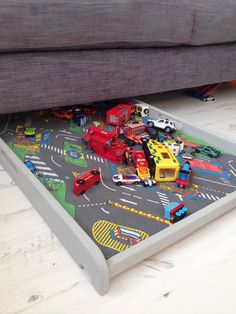 a child's play table with cars and trucks on it