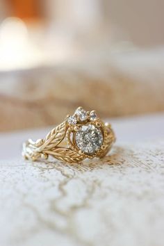 a close up of a gold ring with diamonds on it's center and side