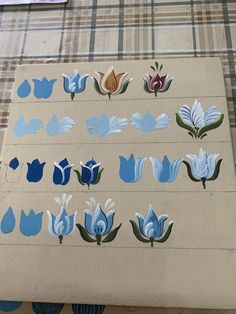 several pieces of paper with blue and white flowers on them