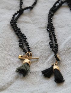 "Gold tassel eucalyptus fruit shape pendent made of brass with 22K gold plating (nickel free) and special hand made knitted black cotton thread with spinel and black miyuki chain. This Gold & black unique necklace is handmade with great attention to details, the organic golden piece is cast originally from nature and this is what makes each pendant different from one other. It is lightweight and comfortable to wear (the cotton chain it is a great solution for people with metal allergies), su Black Tassel Necklace With Adjustable Fit, Black Tassel Necklaces As Gift, Black Tassel Necklace Gift, Black Tassel Necklace As Gift, Adjustable Black Tassel Necklace, Bohemian Black Hand Knotted Jewelry, Adjustable Black Hand Knotted Necklace, Black Hand Knotted Adjustable Necklace, Organic Necklace