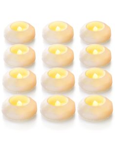 twelve yellow tealight candles are arranged in rows