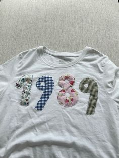 a white t - shirt with the number eight printed on it