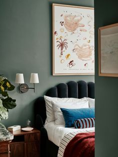 a bedroom with green walls and white bedding