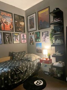 a bedroom with posters on the wall and a bed