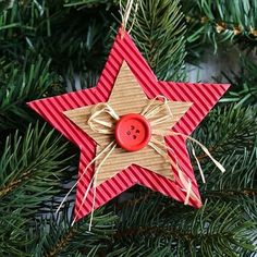 a star ornament hanging from a christmas tree with red and white stripes on it