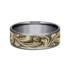 a wedding band with an intricate design in gold and silver, on a white background