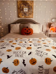 a bed with pumpkins and jack - o'- lanterns on it