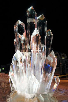 a crystal sculpture sitting on top of a pile of rocks