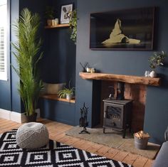 a living room filled with furniture and a fire place in front of a painting on the wall