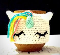 a crocheted cup with a unicorn's face on it