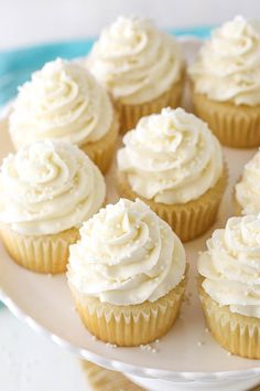 cupcakes with white frosting on a plate