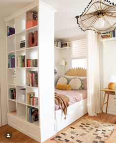 a bedroom with bookshelves and a bed in it