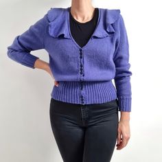 Beautiful vintage ladies cardigan in violet with frilly v-neckline collar. It has a high, ribbed hemline and sparkly, black buttons fastening. Medium thickness, warm, made from soft wool mix yarn. Perfect cardigan for all seasons! No brand label. No material label, wool and polyester mix. No size label, would fit Small to Medium. (Worn on 168cm tall and 12UK). Measurements when laid flat are: Pit to pit: 50cm Waist: 36cm Hemline: 30 - 47cm Sleeve length: 66cm Length: 61cm. Excellent condition. B Fitted Vintage Purple Sweater, Vintage Purple Winter Tops, Fitted Purple Cardigan With Buttons, Vintage Purple Cardigan For Winter, Vintage Purple Winter Cardigan, Purple Vintage Winter Cardigan, Frilly Collar, Ladies Cardigan, Perfect Cardigan