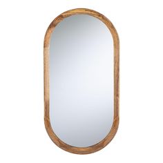 an oval wooden mirror hanging on the wall