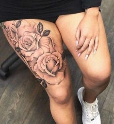 a woman's legs with roses on them and her leg tattoo design in black ink