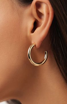 Our large chunky gold hoop earrings are a bold, solid gold statement piece for the modern trendsetter. Elevate your style with these eye-catching and super unique hoops that effortlessly blend timeless elegance with contemporary flair. Waterproof, tarnish-proof recycled solid gold Wear on its own or part of a stack Timeless, solid gold that goes with everything Width: 28.3mm - 1.11" Depth: 4mm - 0.15" Weight:1.38g Hoop Diameter: 28.3mm - 1.11" Post: 10K Solid Gold Post Crafted In Italy Chunky Gold Hoop Earrings, Anniversary Sale, Gold Hoop, Gold Hoop Earrings, Trend Setter, Statement Pieces, The Modern, Timeless Elegance, Gold Earrings