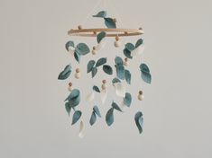 Bring a touch of nature into your nursery with this enchanting Forest Baby Crib Mobile. Featuring delicate leaves in shades of eucalyptus green, this Leaf Baby Mobile adds a calming and organic feel to any baby's space. This Eucalyptus Floral Nursery Mobile is the perfect gender-neutral addition to your décor, creating a soothing ambiance for your little one to drift off to sleep. Handcrafted with care, this Hanging Mobile makes a thoughtful Baby Shower Gift for expecting parents who appreciate Green Floral Nursery, Tree Baby Mobile, Wild Flower Baby Mobile, Macrame Mobile Nursery, Mobile Bebe Theme Nature, Nature Themed Nursery, Macrame Cot Mobile, Natural Nursery, Enchanting Forest