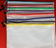 six mesh bags are lined up on top of each other, with zippers in the middle