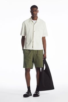 Functional at their core, these utility shorts have been cut from lightweight cotton, to a relaxed fit. Featuring a partially elasticated waistband with an adjustable belt, they are flexible in fit, whist the multi-pocketed design ensures practicality. We suggest pairing them with an oversized T-shirt. Relaxed fitPartially elasticated waist with front fly fasteningGrosgrain beltTwo side slip pockets and two rear welt pockets Shell: 100% Cotton. Pocket lining: 100% Cotton. Excluding trims / Machine wash Inside leg length of size 32R is 21.65cm / Model wears a size 32R Japan Fashion Street, Utility Shorts, Japan Fashion, Oversized T Shirt, Adjustable Belt, Oversized Tshirt, Welt Pocket, Mens Shirts, Trousers