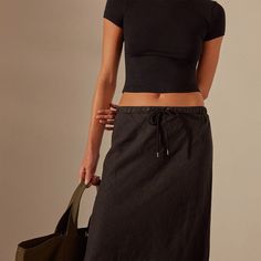 Our High Low Linen Skirt is made in our classic lightweight linen that is breathable and soft. Style details include self waistband with drawcord, slightly high low hem, clean finished hemline and cut on the bias for a flattering fit. Garment dyed.Additional Information:• 100% Linen • Machine wash cold, tumble dry lowStyled With:• WMTP3926 - Short Sleeve Cropped Tee • SWTSU8402 - Women's Single Strap Platform Slide Fitted Linen Casual Maxi Skirt, Casual Fitted Linen Maxi Skirt, Fitted Linen Maxi Skirt Casual Style, Cotton Maxi Skirt With Drawstring And Relaxed Fit, Cotton Maxi Skirt With Drawstring, Relaxed Drawstring Skirt For Work, Casual Black Linen Skirt, Casual Drawstring Skirt For Work, Denim Polo