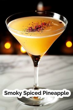 a cocktail in a martini glass with the words smoky spiced pineapple