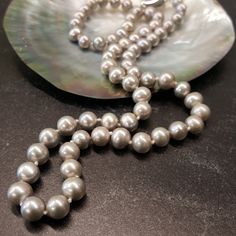 Introducing the Timeless Elegance of our Single Strand Gray Pearl Necklace: A Classic Beauty that Transcends Trends Immerse yourself in the ethereal allure of our exquisite 18-Inch Gray Pearl Necklace. Meticulously crafted with the finest freshwater pearls, this timeless accessory encapsulates the essence of elegance, grace, and sophistication. Prepare to be captivated by the luminescent beauty of each pearl adorning this single strand necklace. Gently knotted together, these lustrous gray pearl Gray Pearl Necklace, Pearl Necklace Freshwater, Grey Pearl Necklace, Real Pearl Necklace, Pearl Strands Necklace, Pearl Gifts, Reflecting Light, Pearl Strand, Popular Jewelry