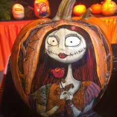 a pumpkin decorated with an image of jack and sally from the nightmare before it's gone