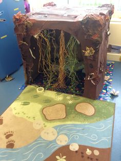 a child's play area in the shape of a cave with plants growing out of it