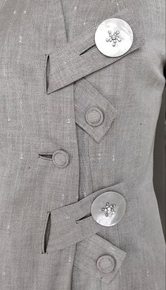 the back of a suit with buttons on it