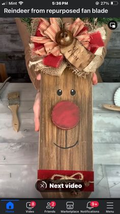 someone is holding up a wooden box with a fake reindeer head on it's side