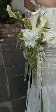 a woman in a wedding dress holding a bouquet